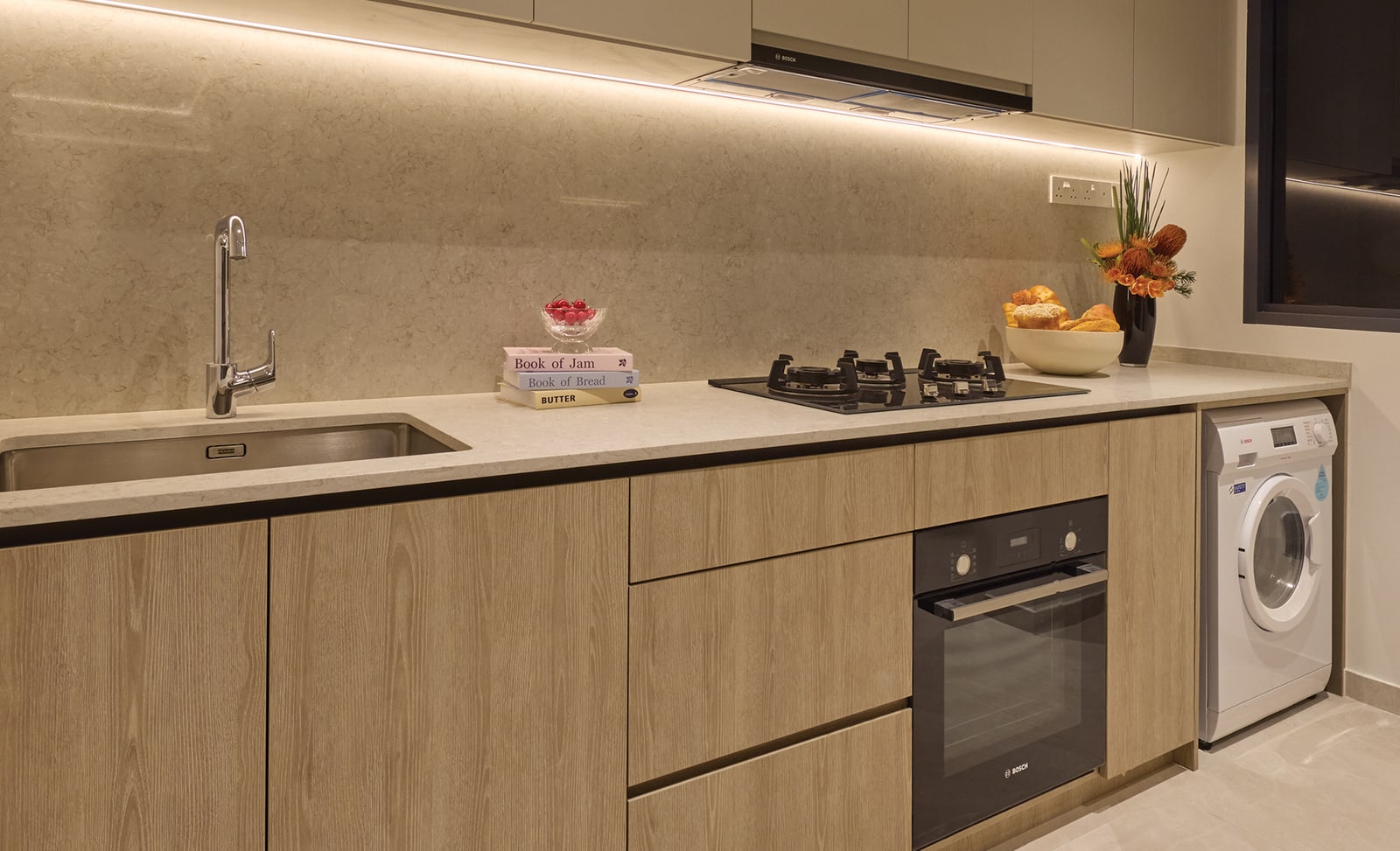Illustration of a kitchen with a hob, an oven and a washer-dryer
