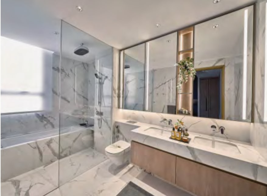 Interior picture of a marble bathroom with a glass shower and a double vanity