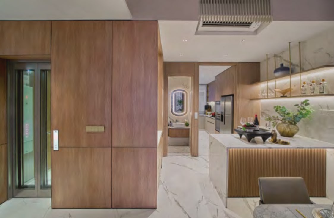 Interior picture of the private lift door and a kitchen island with a wet kitchen beyond