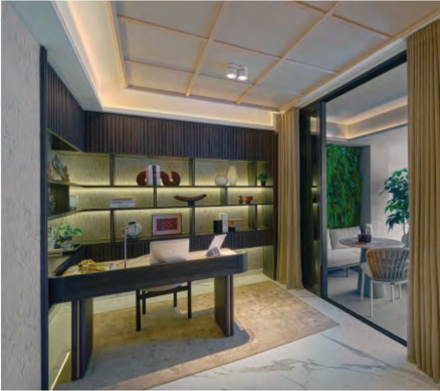 Interior picture of a study with a desk, wall shelves and a glass door to a terrace