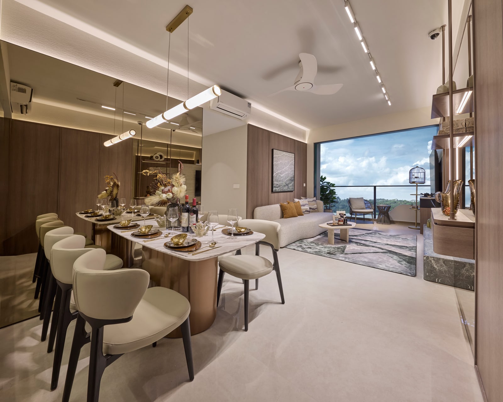 Living and dining area of a 3-bedroom home opening onto a balcony with a view of greenery
